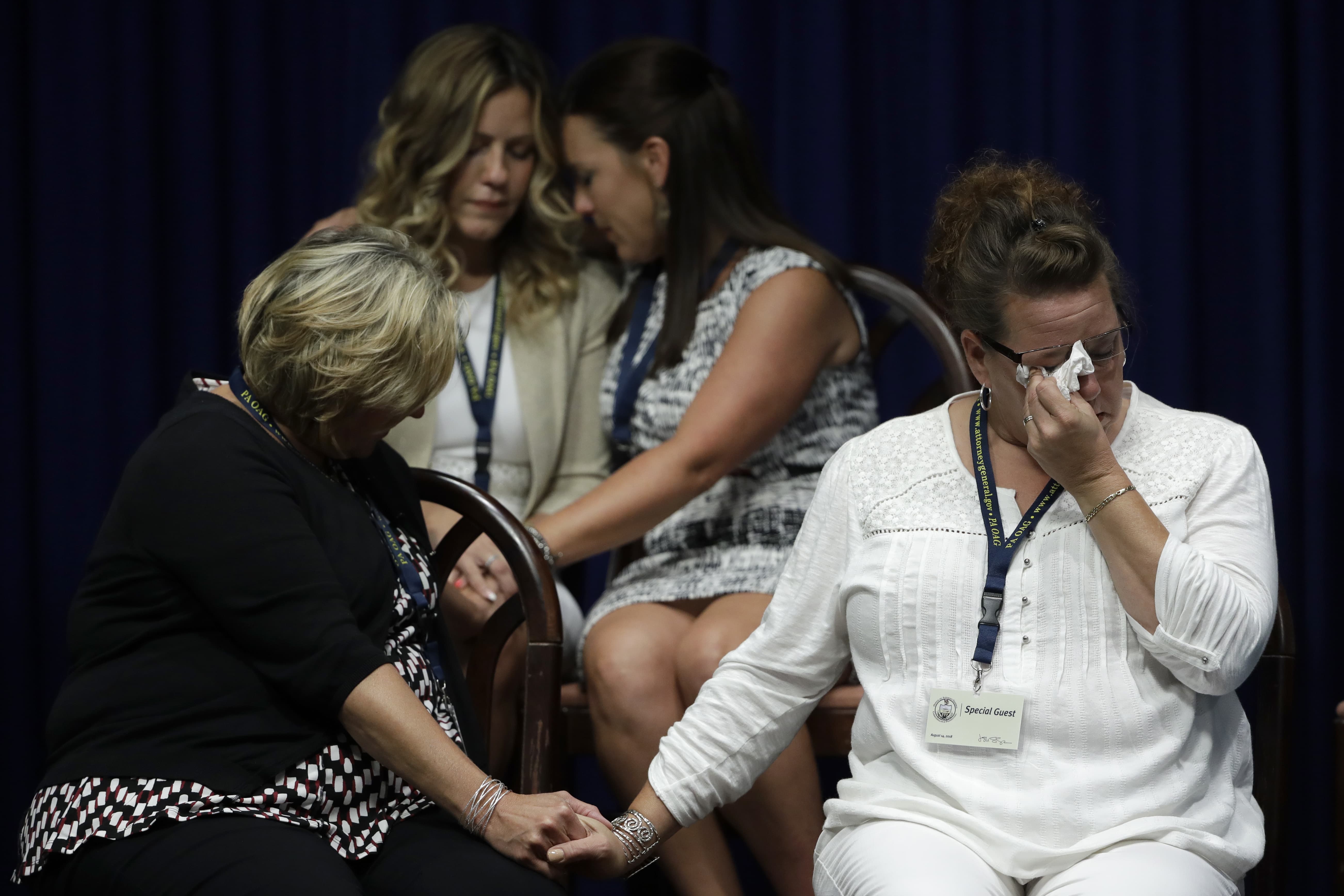 Victims of clergy sexual abuse, or their family members react as Pennsylvania Attorney General Josh Shapiro speaks during a news conference at the Pennsylvania Capitol in Harrisburg, Pa., Tuesday, Aug. 14, 2018. A Pennsylvania grand jury says its investigation of clergy sexual abuse identified more than 1,000 child victims. (Matt Rourke/AP)