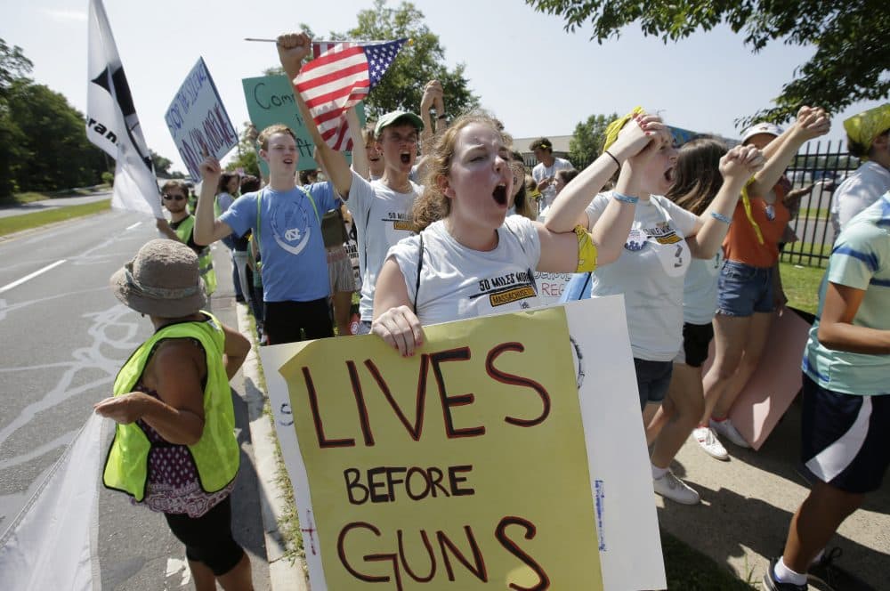 Chloe Carr, 18, of Natick, front, holds a placard and chants slogans during the final mile of a 50-mile march. The march, held to call for gun law reforms, began Thursday in Worcester and ended Sunday, in Springfield, with a rally near the headquarters of gun manufacturer Smith & Wesson. (Steven Senne/AP)
