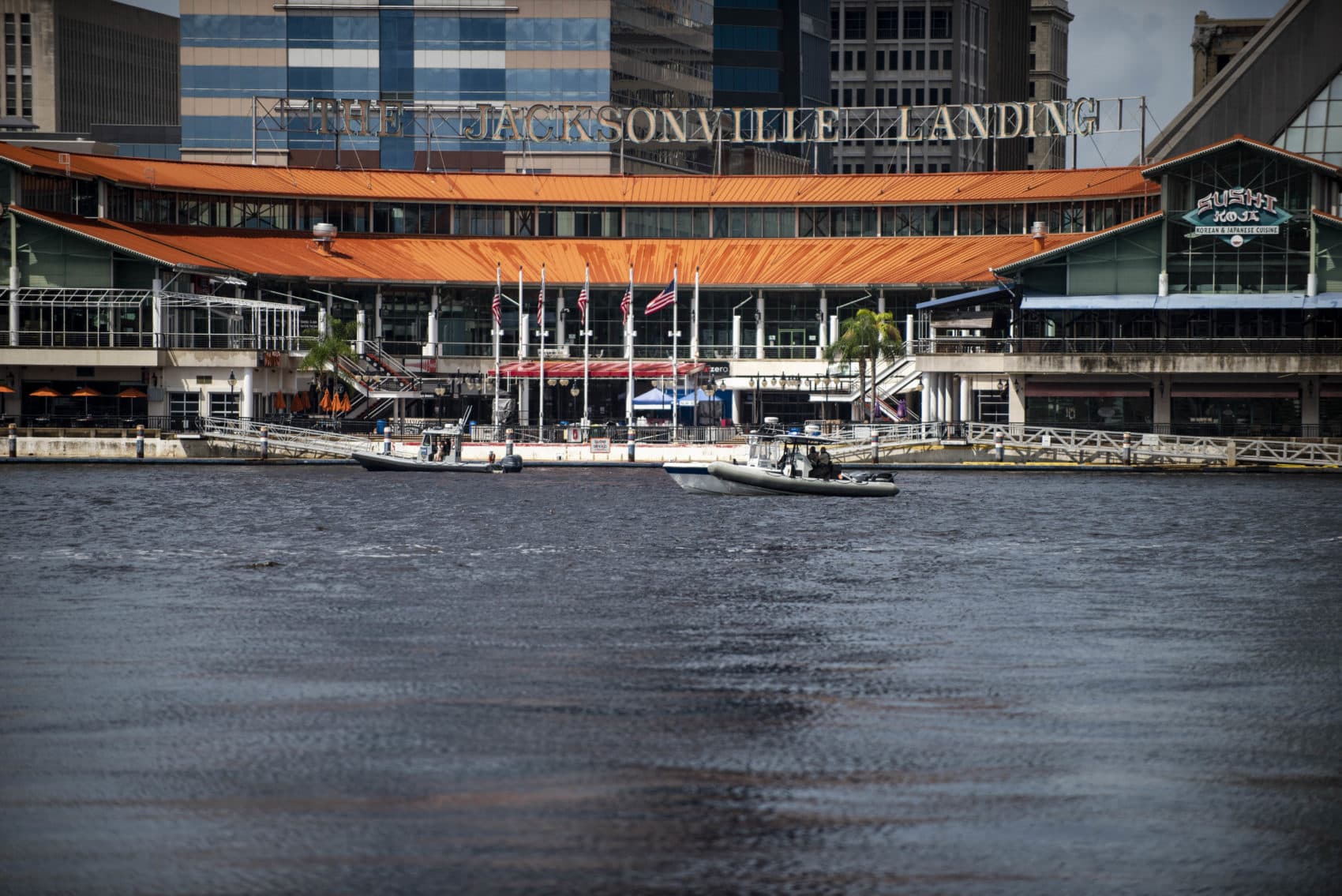 Police patrol the St. Johns River by boat just outside the Jacksonville Landing complex, where there was a shooting Sunday. (Laura Heald/AP)