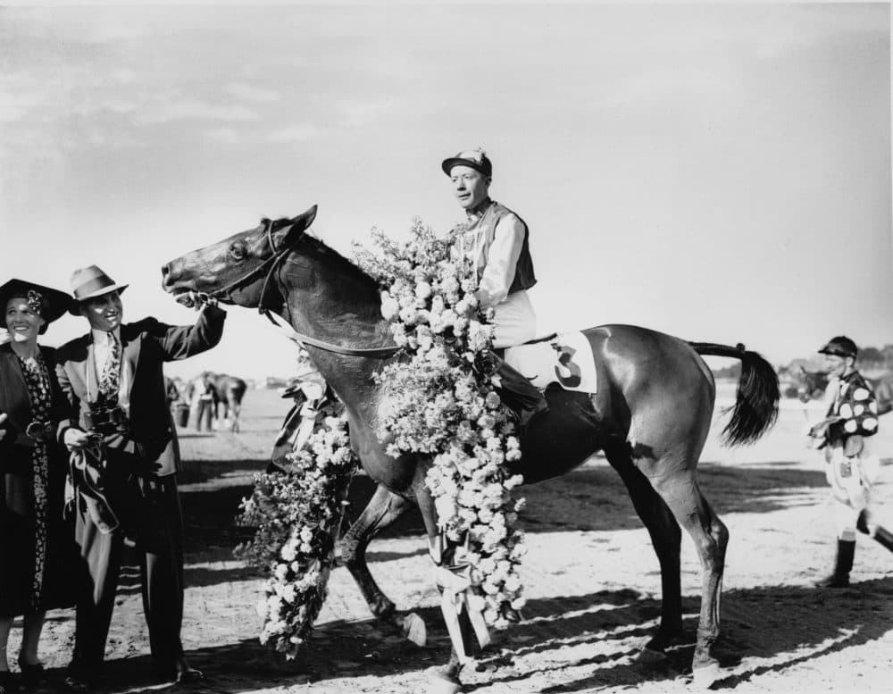 Seabiscuit, wearing the victory flower garland, is shown with jockey Johnny &quot;Red&quot; Pollard after winning the $51,780 Massachusetts Handicap at Suffolk Downs on Aug. 7, 1937. (AP)