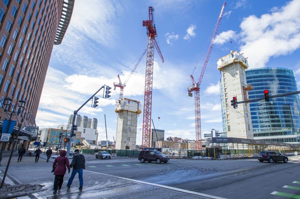 Cranes stretch into the sky over what will become three-buildings of luxury apartments and condominiums, the Echelon Seaport. (Jesse Costa/WBUR)