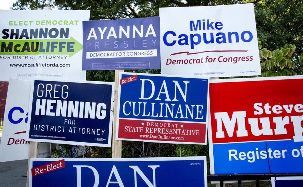 Campaign boards outside the Adams Street Library in Dorchester (Robin Lubbock/WBUR)