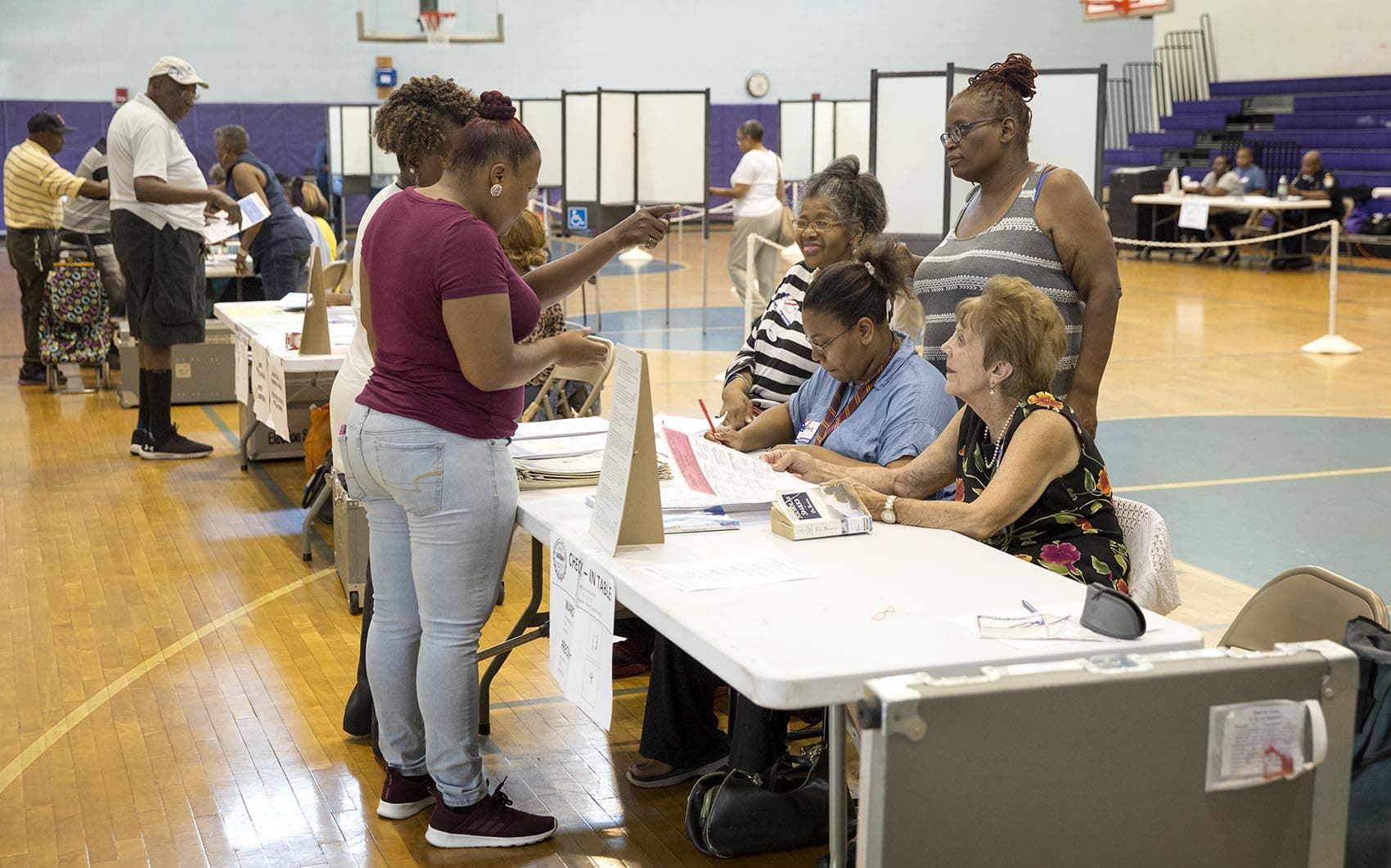 Voters check in to vote at the Lilla G. Frederick Pilot Middle School in Dorchester. (Robin Lubbock/WBUR)