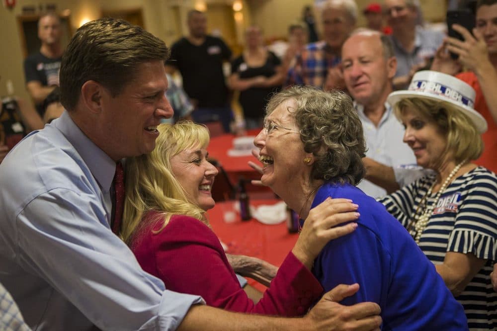 Geoff Diehl and his wife KathyJo Boss, center, greet a supporter after his Republican U.S. Senate primary win. (Jesse Costa/WBUR)