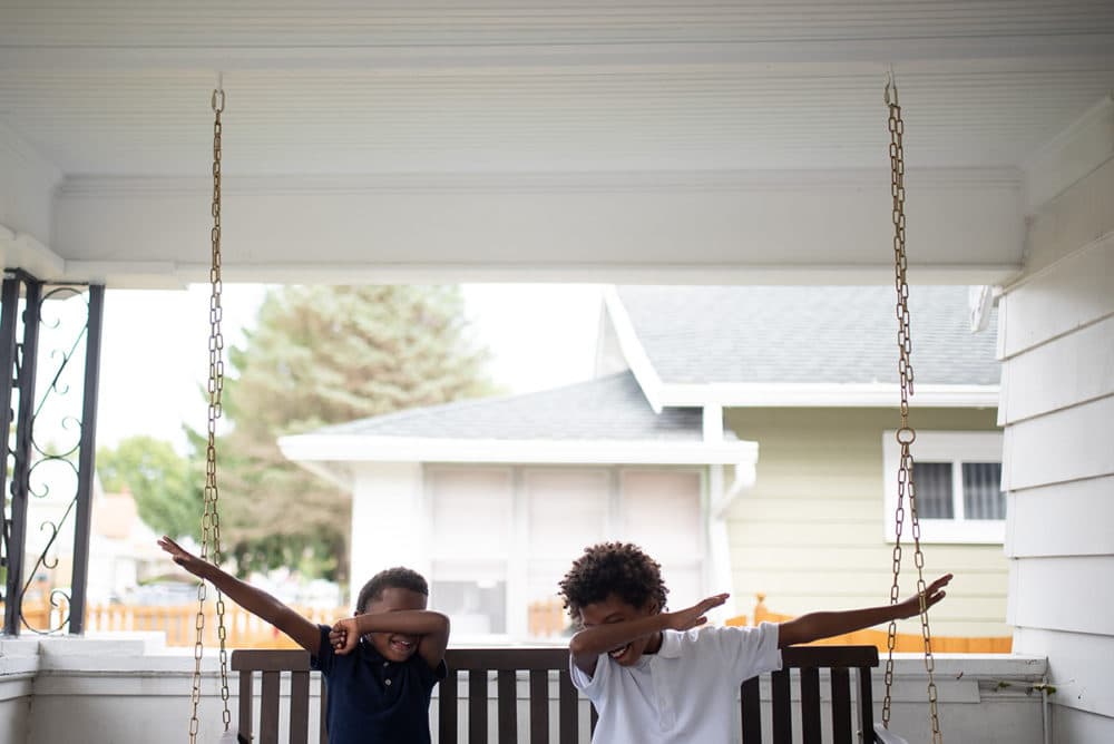 Ocean, 6, and Josh, 8, dab on the front porch adjacent to The Biker Boyz &amp; Girlz Shop in Indianapolis. (Lucas Carter for Here &amp; Now)