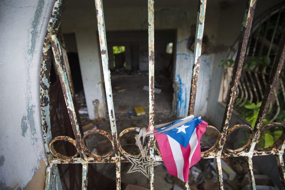 An abandoned house in Barrio-Bravos De Boston in Cantera, San Juan, left by its owners due to the prolonged wait to restore electricity in the area after Hurricane Maria. The house was then used by drug users for a time before local residents drove them out -- with plans now to clean it up. (Jesse Costa/WBUR)