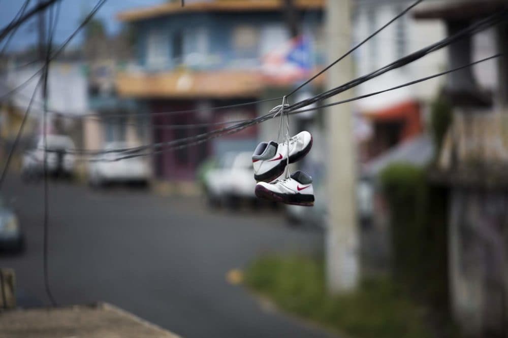 A pair of sneakers hangs from electrical wires on Av. Haydee Rexach in Barrio Obrero, San Juan. (Jesse Costa/WBUR)