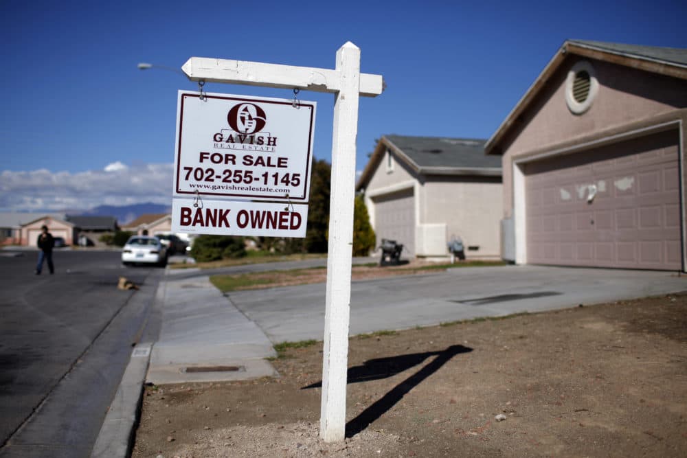 FILE - In this file photo taken Feb. 18, 2009, a for sale sign stands outside a bank-owned home in North Las Vegas. (AP Photo/Jae C. Hong, File)
