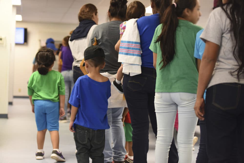 In this Thursday, Aug. 9, 2018, photo, provided by U.S. Immigration and Customs Enforcement, mothers and their children stand in line at South Texas Family Residential Center in Dilley, Texas. Currently housing 1,520 mothers and their children, about 10 percent are families who were temporarily separated and then reunited under a zero tolerance policy that has since been reversed. (Charles Reed/U.S. Immigration and Customs Enforcement via AP)
