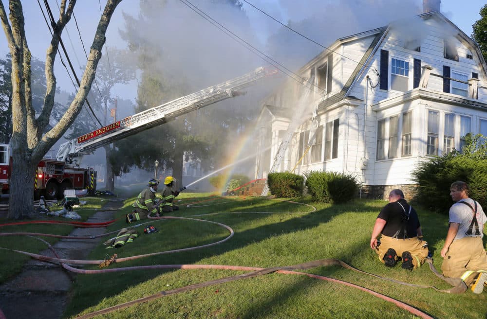 Firefighters battle a house fire on Herrick Road in North Andover. (Mary Schwalm/AP)