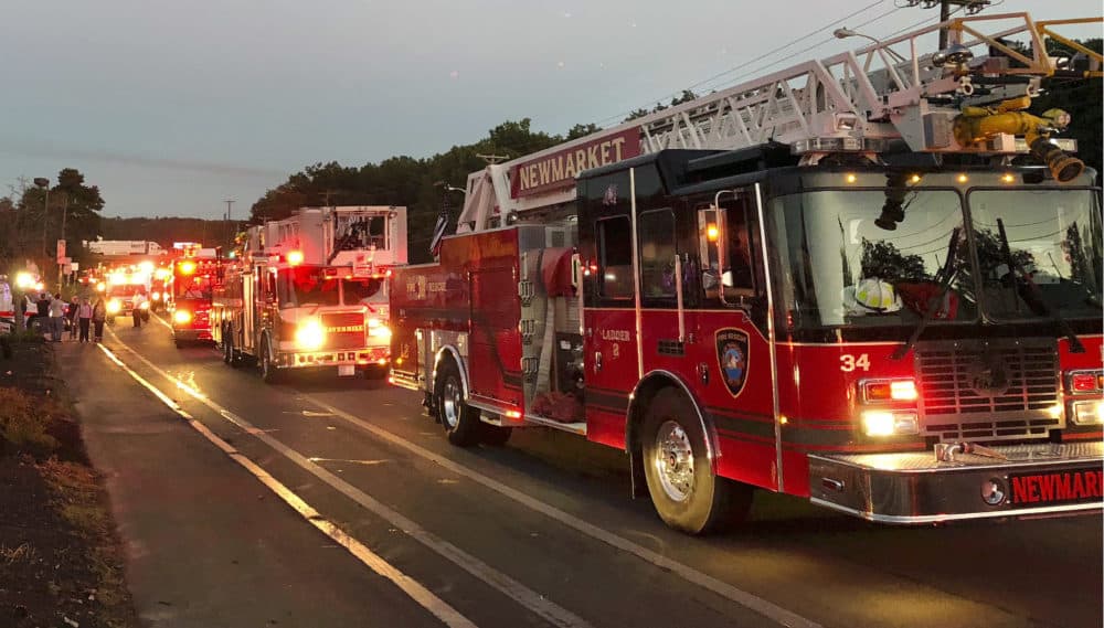 Multiple fire trucks from surrounding communities arrive Thursday in Lawrence. (Phil Marcelo/AP)