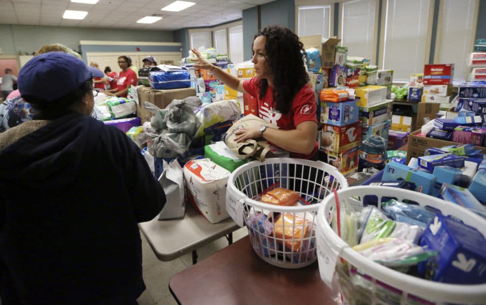 Volunteers at the Senior Center in Lawrence hand out food and supplies Tuesday, in the wake of last week's gas explosions and house fires in the Merrimack Valley. (Elise Amendola/AP)