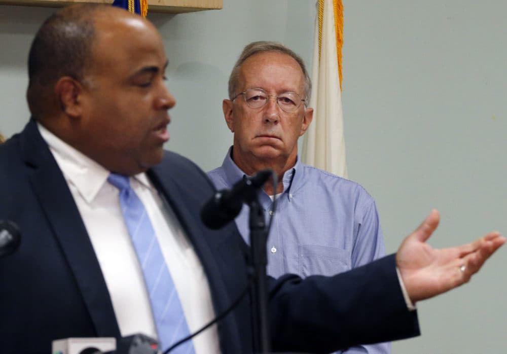 Columbia Gas CEO Steve Bryant, right, listens as Lawrence Mayor Dan Rivera speaks at a news conference Tuesday, regarding last week's gas explosions and house fires in the Merrimack Valley. The utility is donating $10 million to an emergency relief fund for people affected by the emergency. (Elise Amendola/AP)