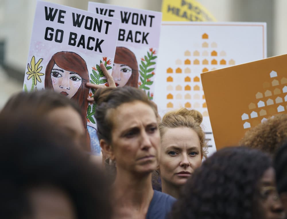 Protesters with Women's March and others hold up signs that read "We Won't Go Back" as they gather in front of the Supreme Court on Capitol Hill in Washington, Monday, Sept. 24, 2018. (Carolyn Kaster/AP)