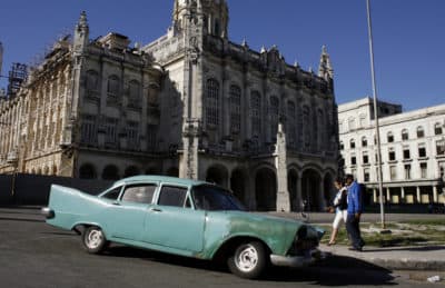 People walk by a classic car parked outside the Revolution Museum in Havana in 2008. (AP/Javier Galeano)
