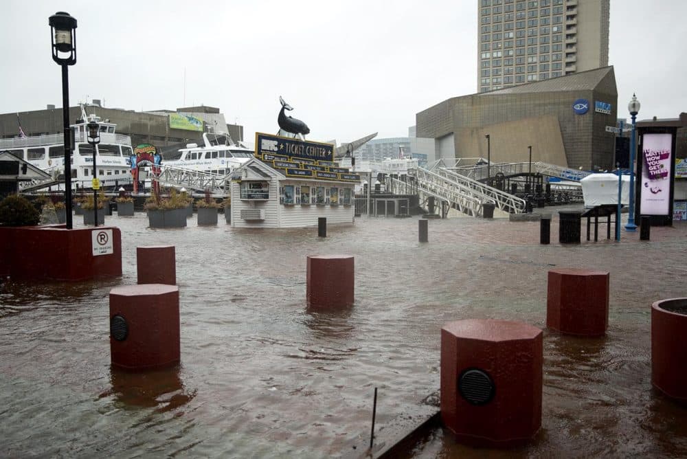 The Boston Harbor Cruises ticket office stands surrounded by water as high tide floods Long Wharf during the March 2018 nor'easter. (Robin Lubbock/WBUR)