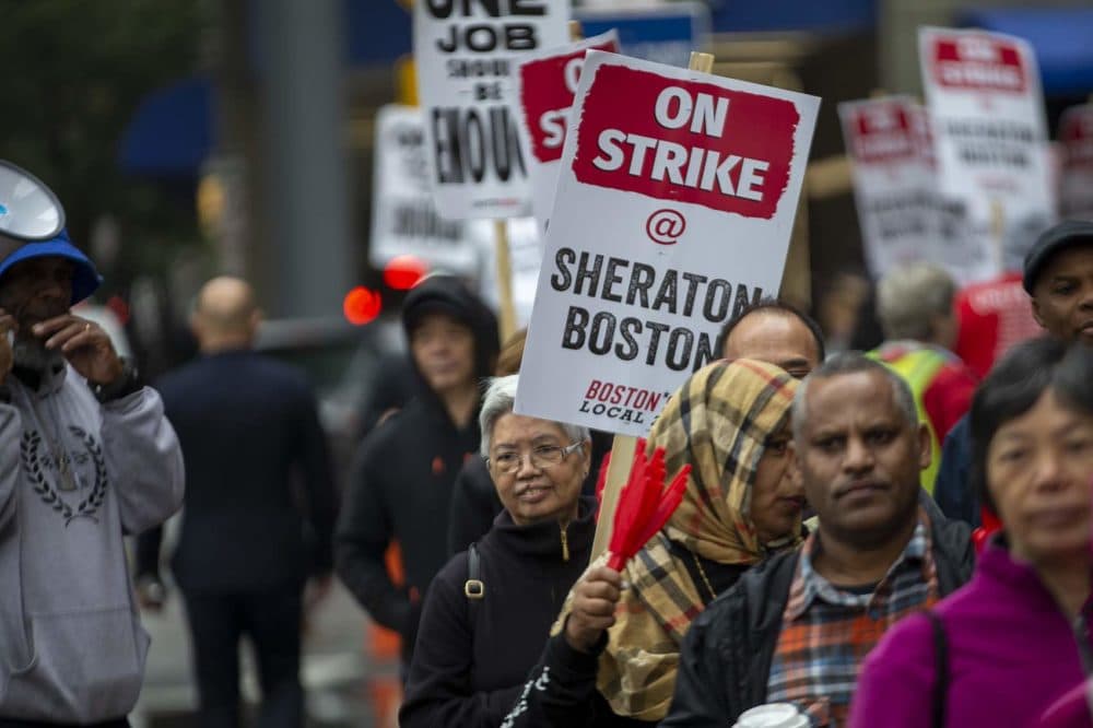 The workers say they want better wages and benefits so they can afford to live in the city. (Jesse Costa/WBUR)