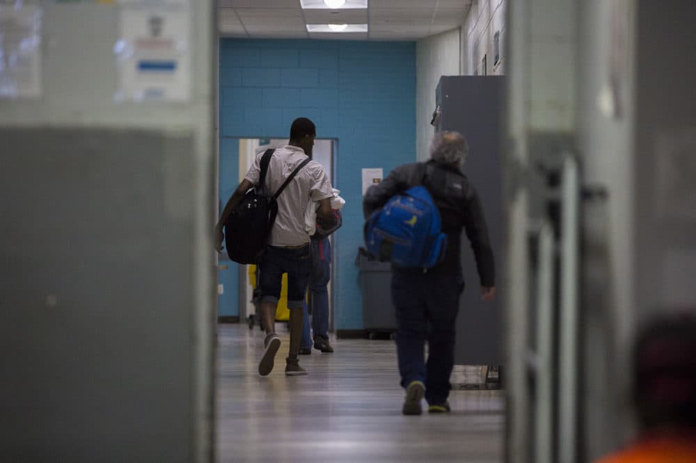 Men at the Southampton Street shelter walk toward offices where triage and other services are offered, as well as the dorms where they sleep. (Jesse Costa/WBUR)