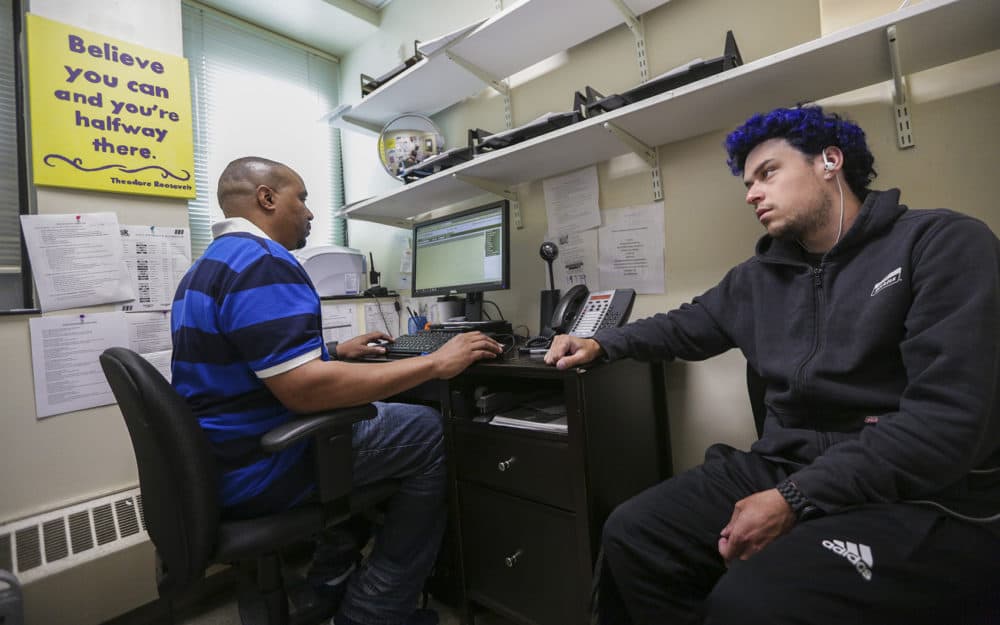 Pine Street Inn triage worker Reggie Santos, left, meets with Jordan Gonzalez. (Jesse Costa/WBUR)