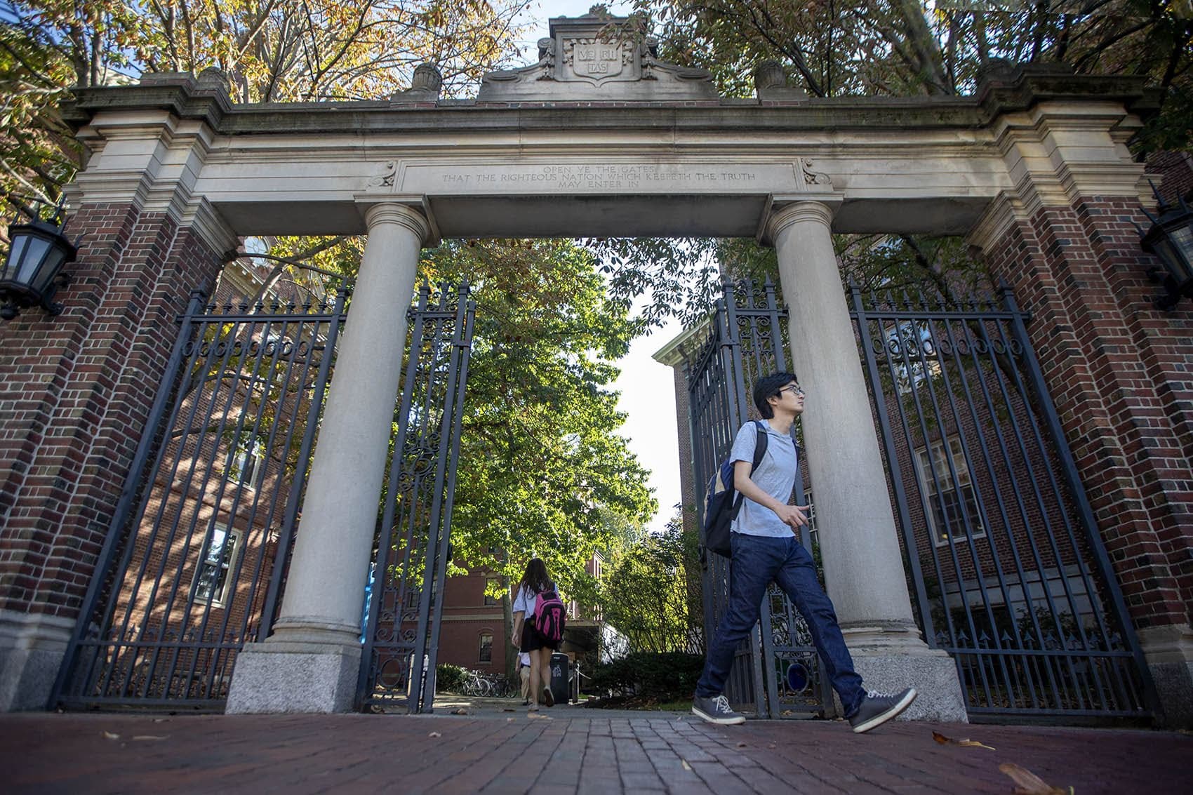 Students walk through the Class of 1875 Gate outside Harvard Yard. (Jesse Costa/WBUR)