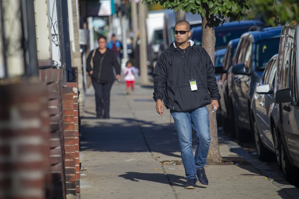 Diego Pizarro, a front line youth worker at Roca, walks down Bennington Street to one of the addresses he obtained from East Boston District Court. (Jesse Costa/WBUR)