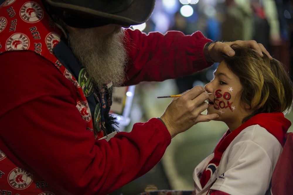 Maddox Legendre, 10, has “Go Sox” painted on his face before the first game of the World Series between the Boston Red Sox and Los Angeles Dodgers at Fenway Park. (Jesse Costa/WBUR)