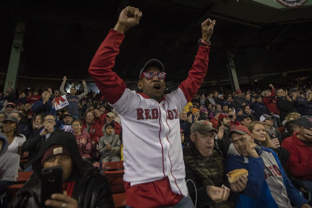 A Red Sox fan cheers as Chris Sale strikes out Dodgers batter Brian Dosier for the first out of the night. (Jesse Costa/WBUR)