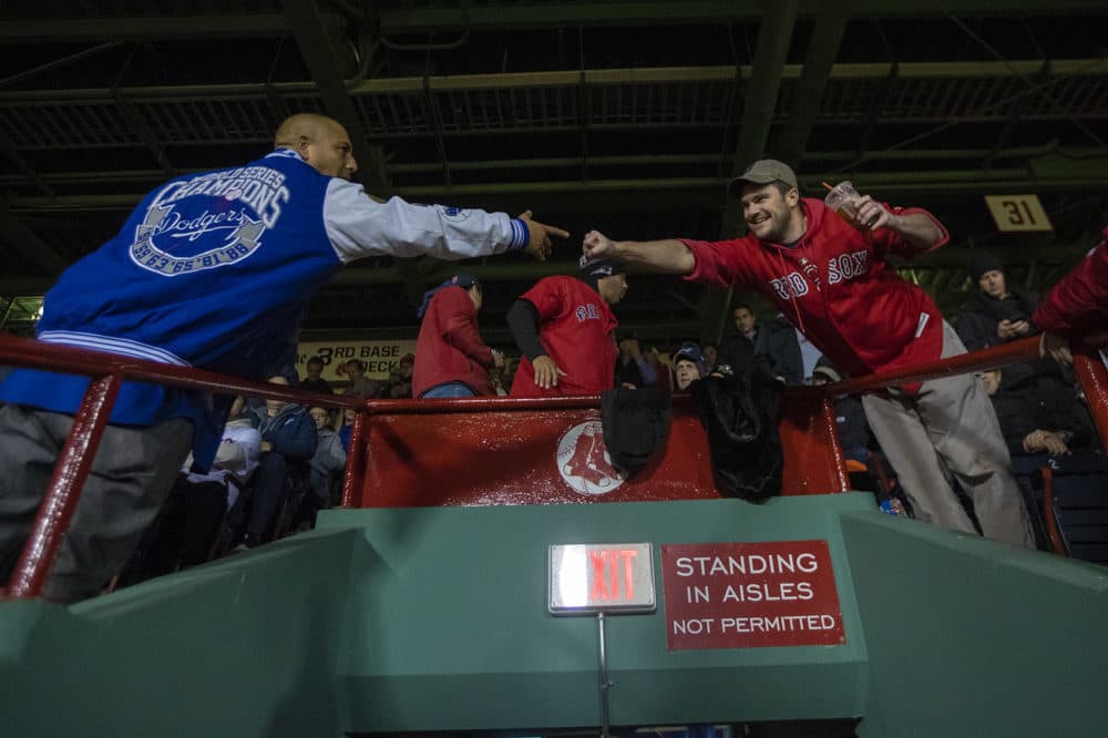 Despite the competion on the field, a Red Sox and a Dodgers fan manage to fist bump one another during the game. (Jesse Costa/WBUR)