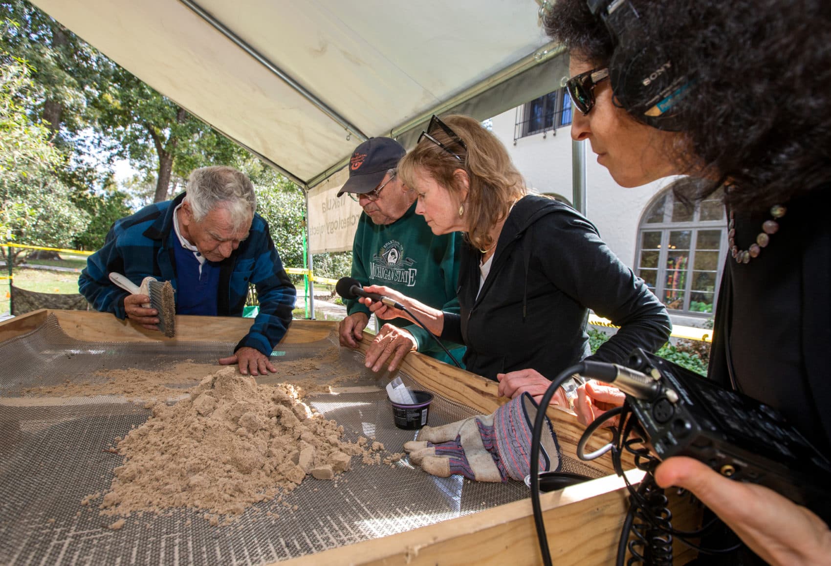 Here & Now's Robin Young, second from right, and Karyn Miller-Medzon conduct interviews during an excavation at Wakulla Springs State Park, south of Tallahassee. (Mark Wallheiser for Here & Now)