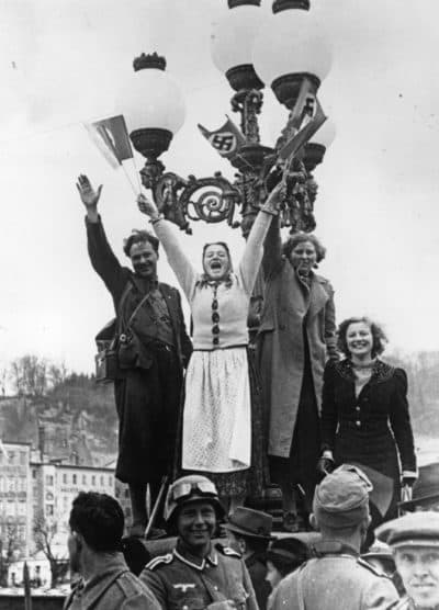 Austrian women wave swastikas to celebrate the union of Austria and Germany. (Keystone/Getty Images)
