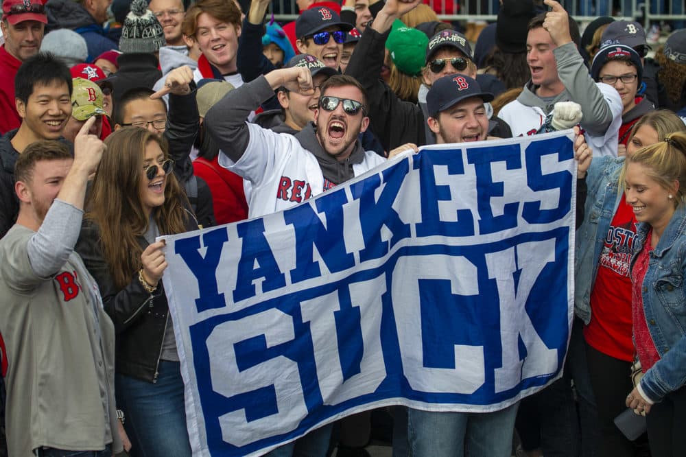 Fans with a banner chant “Yankees Suck” during the rally in Copley Square. (Jesse Costa/WBUR)