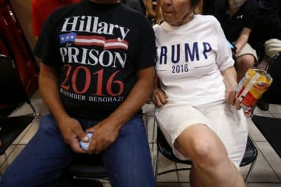 Ron Capitena, left, and Celeste Corbissero, of Ashtabula, Ohio, wear anti-Hillary Clinton and pro-Trump shirts as they wait for Donald Trump to deliver remarks in Youngstown, Ohio, Monday, Aug. 15, 2016. (Gerald Herbert/AP)