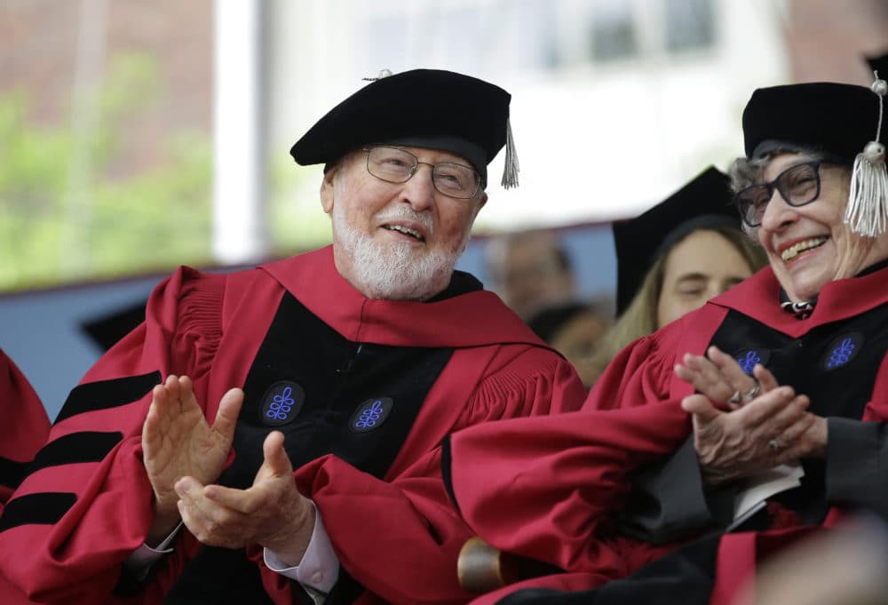 Composer John Williams, left, applauds along with literary critic, author, and feminist Sandra Gilbert, right, during Harvard University commencement exercises, Thursday, May 25, 2017, in Cambridge, Mass. Williams received an honorary Doctor of Music degree, while Gilbert received an honorary Doctor of Laws degree Thursday. (AP Photo/Steven Senne)