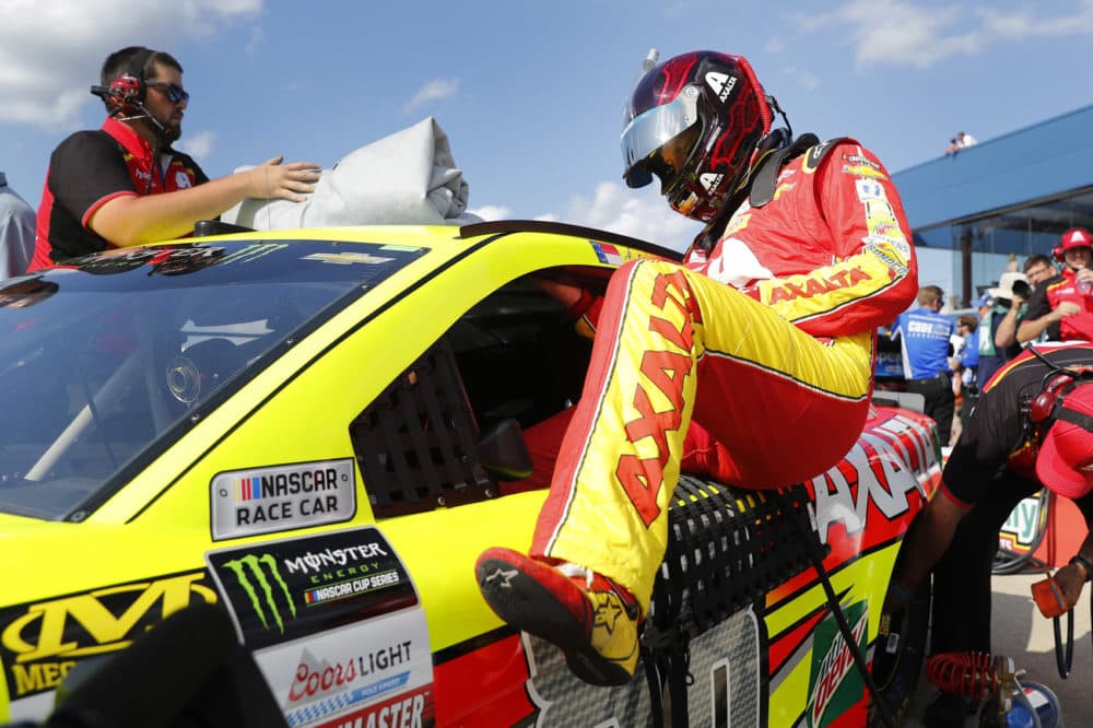 Dale Earnhardt Jr. enters his car for qualifying for the NASCAR Cup Series auto race in Brooklyn, Mich., Friday, Aug. 11, 2017. (AP Photo/Paul Sancya)
