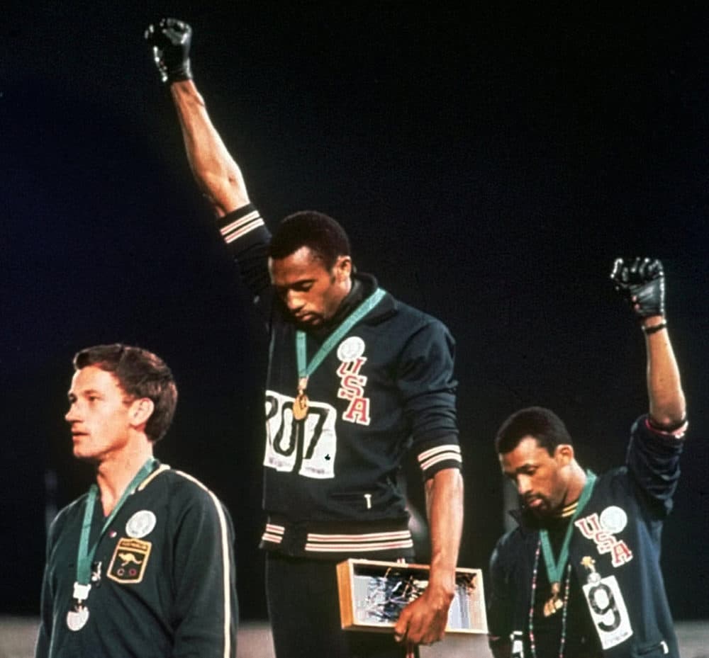 Tommie Smith and John Carlos won gold and bronze, respectively, in the 200-meter run at the 1968 Olympic games. (AP Photo, File)