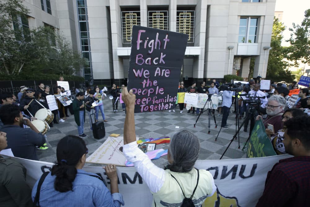 In this June 20, 2018, file photo, more than 100 protesters demonstrate outside the federal courthouse where a federal judge heard arguments over the U.S. Justice Department's request to block three California laws that extend protections to people in the country illegally, in Sacramento, Calif. (Rich Pedroncelli/AP)