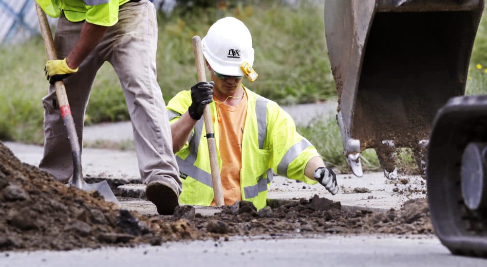 Utility contractors dig up the road above natural gas lines along Dracut Street in Lawrence, Mass., Thursday, Sept. 20, 2018. Nearly 9,000 homes and businesses may be without gas for weeks as investigators continue to probe what set off the explosions last Thursday in the Merrimack Valley area serviced by Columbia Gas of Massachusetts. (Charles Krupa/AP)