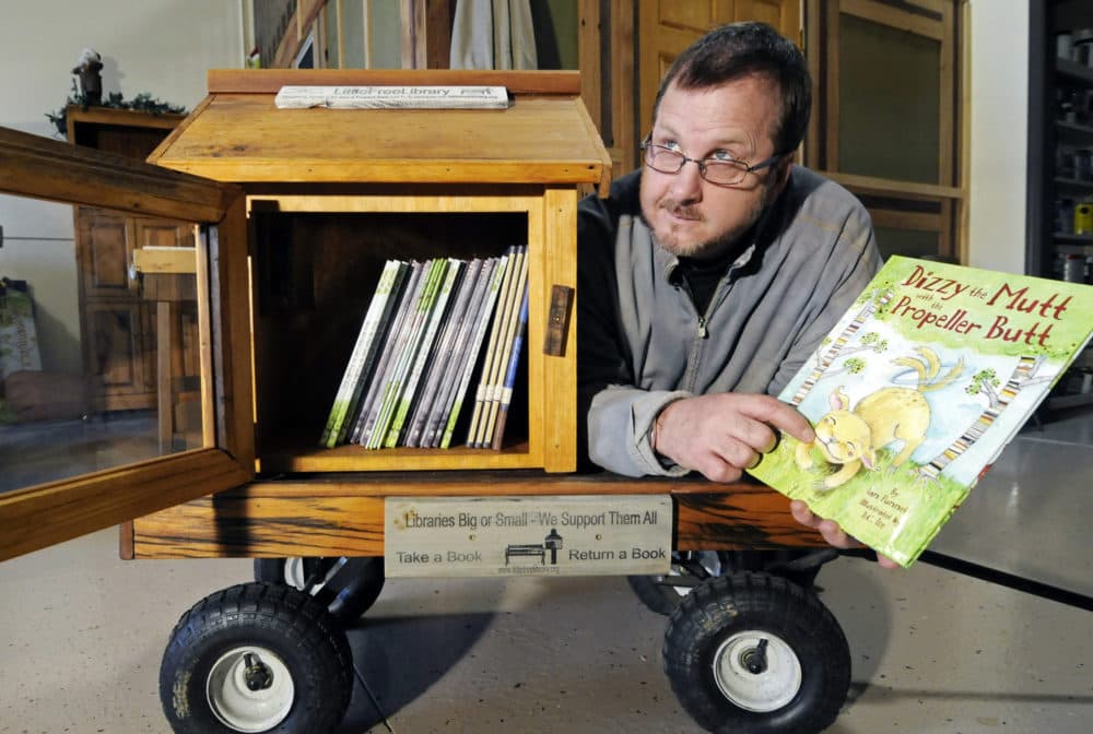 In this 2012 file photo, Todd Bol poses with a Little Free Library lending box in Hudson, Wis. Bol, who founded Little Free Library, died Oct. 18, 2018, in a Minnesota hospice of complications from pancreatic cancer. He was 62. (Jim Mone/AP)