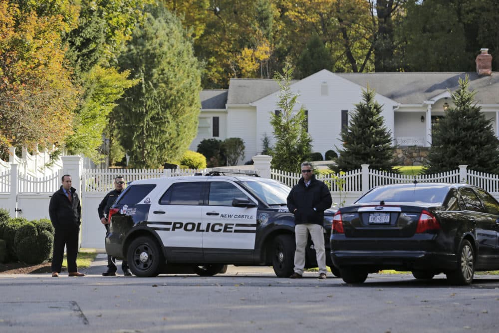 Police officers stand in front of property owned by former Secretary of State Hillary Clinton and former President Bill Clinton in Chappaqua, N.Y., Wednesday, Oct. 24, 2018. A U.S. official says a "functional explosive device" was found at the Clinton's suburban New York home. (Seth Wenig/AP)