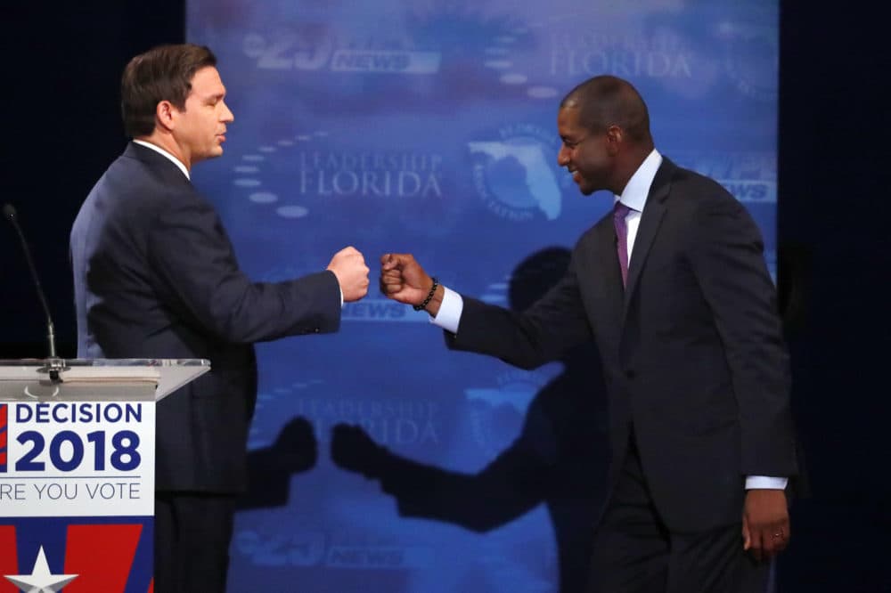 In this Oct. 24, 2018, photo, Florida gubernatorial candidates, Republican Ron DeSantis, left, and Democrat Andrew Gillum fist bump after a debate at Broward College in Davie, Fla. The final stretch of the midterm campaign is increasingly dominated by debate over one of the most sensitive issues in American political culture: Race. In Florida, accusations of racism are playing a central role in the hotly-contested campaign for governor. DeSantis chafed at questions about his ties to supporters who have made inflammatory comments. (AP Photo/Wilfredo Lee, Pool)
