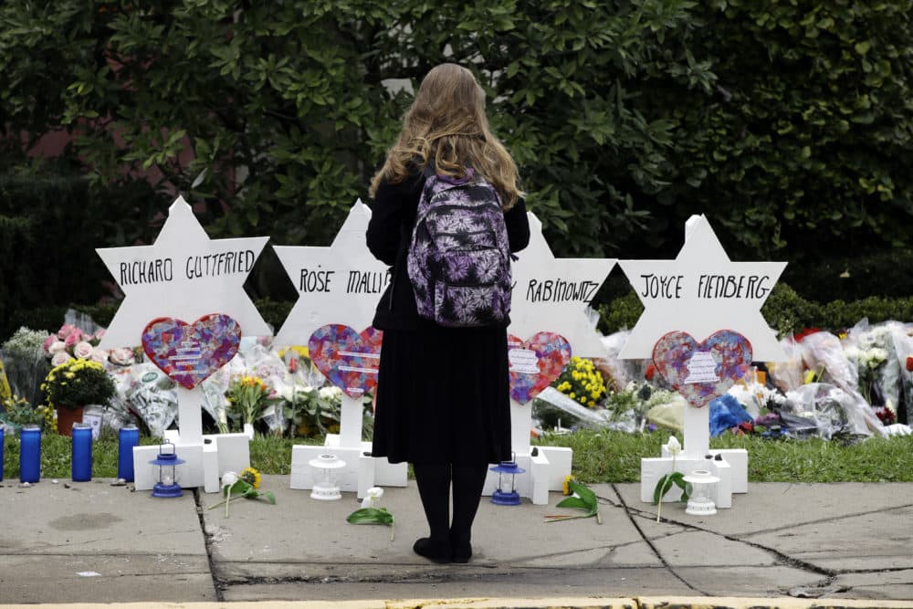 A person stands in front of Stars of David that are displayed in front of the Tree of Life Synagogue with the names of those killed in Saturday's deadly shooting in Pittsburgh, Monday, Oct. 29, 2018. (Matt Rourke/AP)