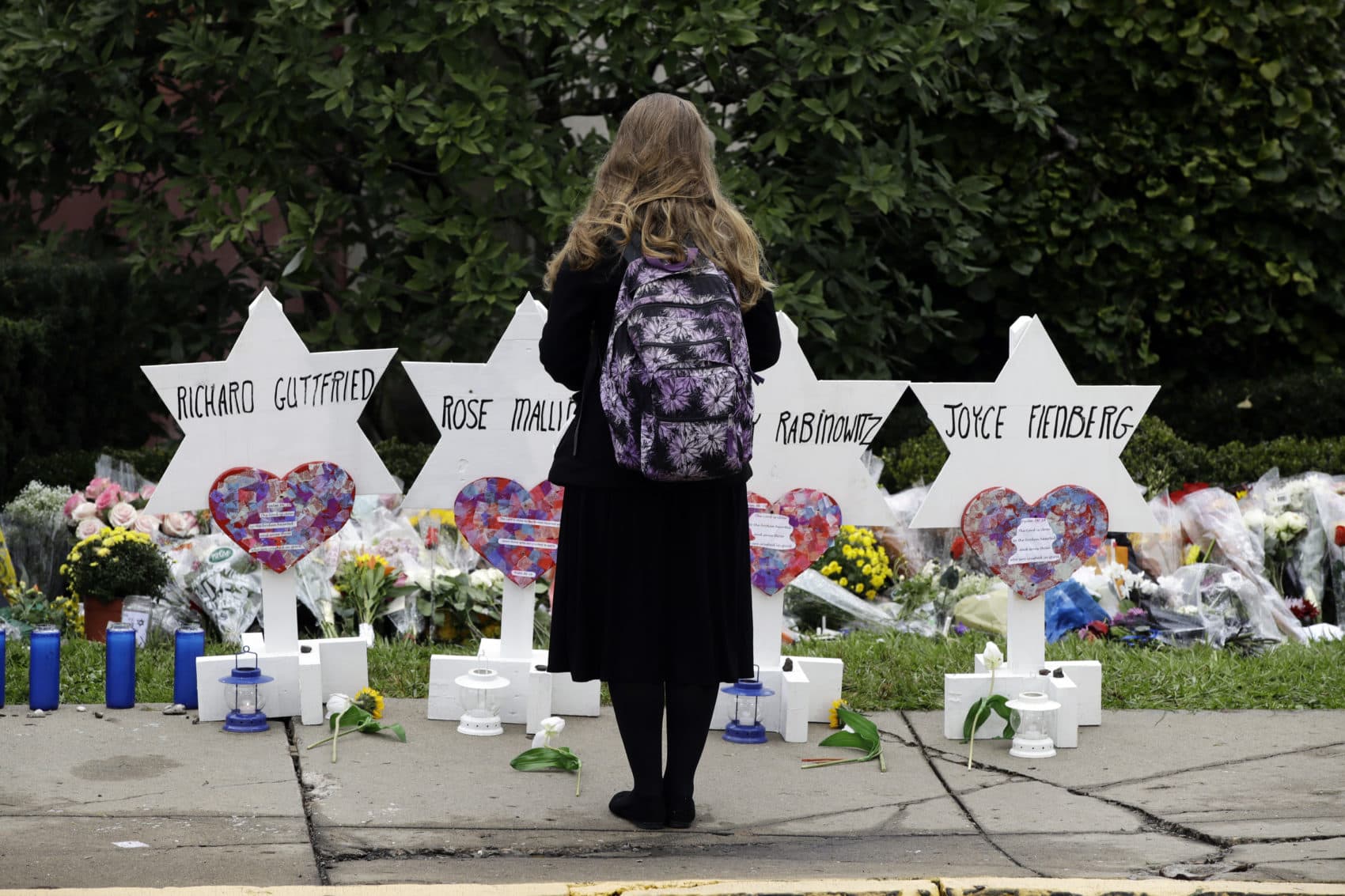 A person stands in front of Stars of David that are displayed in front of the Tree of Life Synagogue with the names of those killed in Saturday's deadly shooting in Pittsburgh, Monday, Oct. 29, 2018. (Matt Rourke/AP)