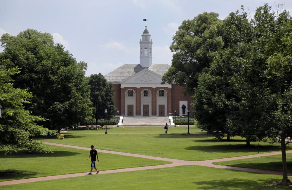 In this July 8, 2014 picture, people walk on Johns Hopkins University's Homewood campus in Baltimore. (AP Photo/Patrick Semansky)