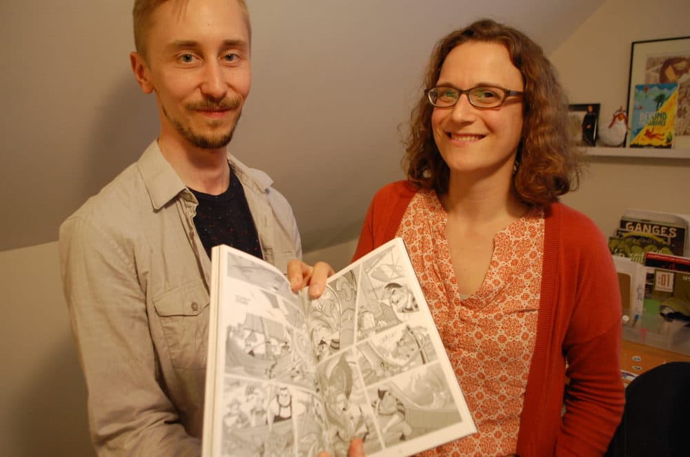 Braden Lamb and Shelli Paroline hold up one of their many collaborative projects. (Dana Forsythe for WBUR)