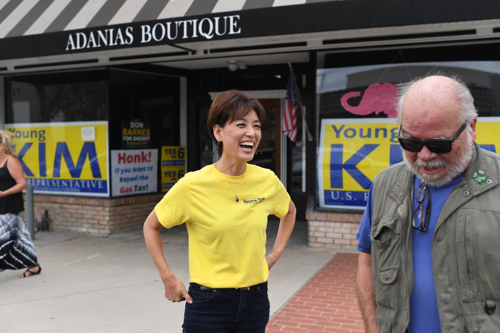 Republican candidate for Congress Young Kim, 55, laughs with a supporter outside her campaign office in Yorba Linda, California, on October 6. (Robyn Beck/AFP/Getty Images)