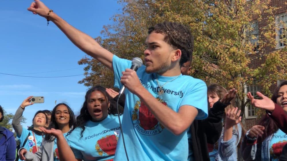 Adelson Aguasvivas performs at a #DefendDiversity rally in Harvard Square on Oct. 14. (Max Larkin/WBUR)