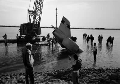 Spirit of America gets lifted out of the salt pond. The pond was only ankle deep, but it hid an 18-foot-deep trench that swallowed the jet car. (Courtesy Craig Breedlove)