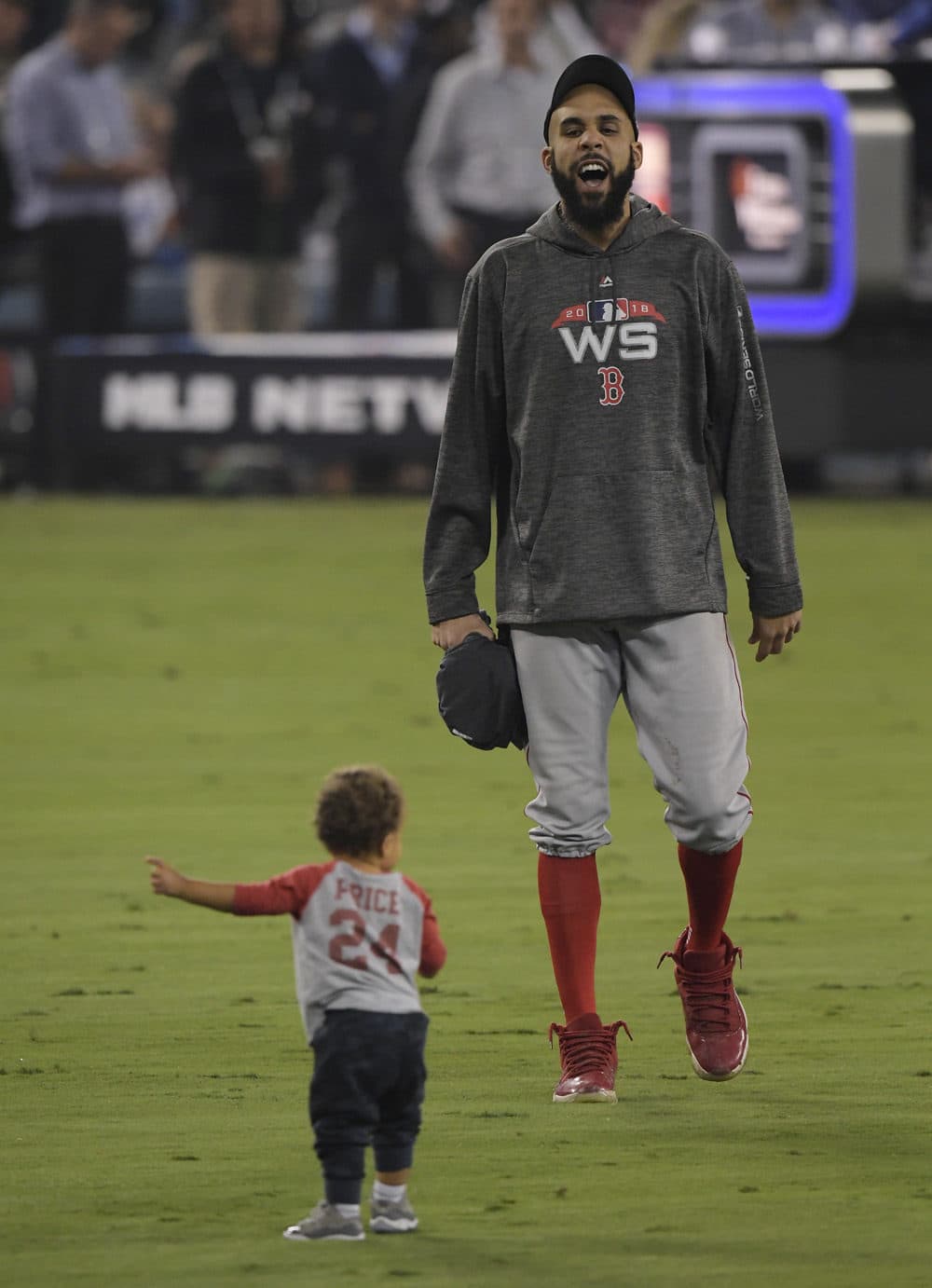 Boston Red Sox pitcher David Price celebrates with his son Xavier after Game 5 of baseball's World Series against the Los Angeles Dodgers. (Mark J. Terrill/AP)