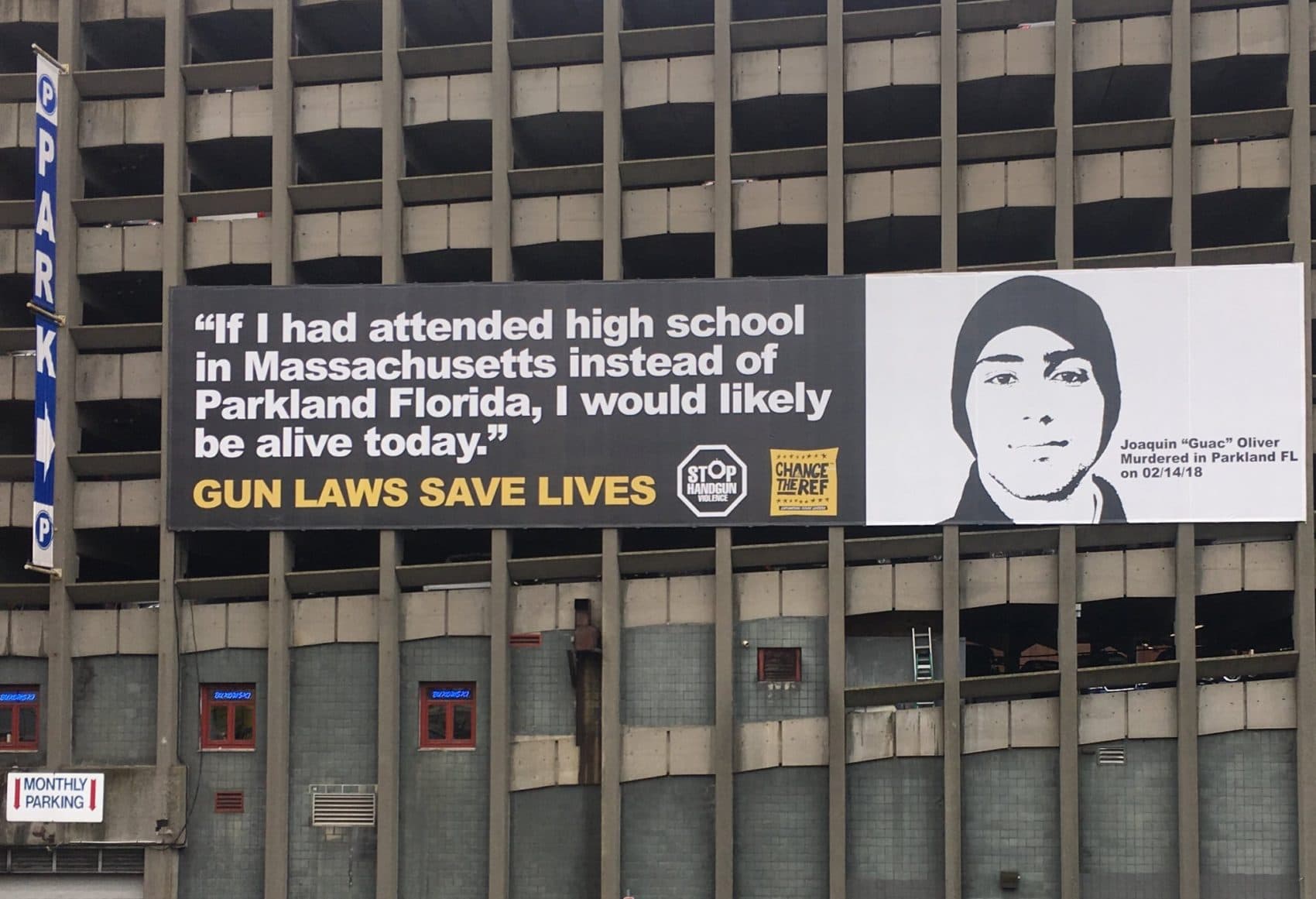 Parents of Parkland shooting victim Joaquin Oliver joined state and federal officials for the unveiling of a billboard over the Massachusetts Turnpike in the Back Bay, calling for other states to replicate Bay State gun laws. (Katie Lannan/SHNS)
