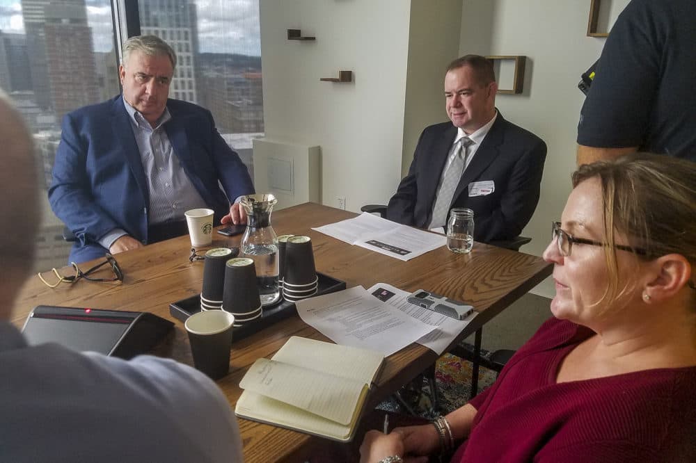Former Boston Police Commissioner Ed Davis (left) and state Trooper Sean Maloney took part in an exercise at Boston-based Cybereason where they ran through scenarios of different types of hacks that could happen during an election. (Zeninjor Enwemeka/WBUR)